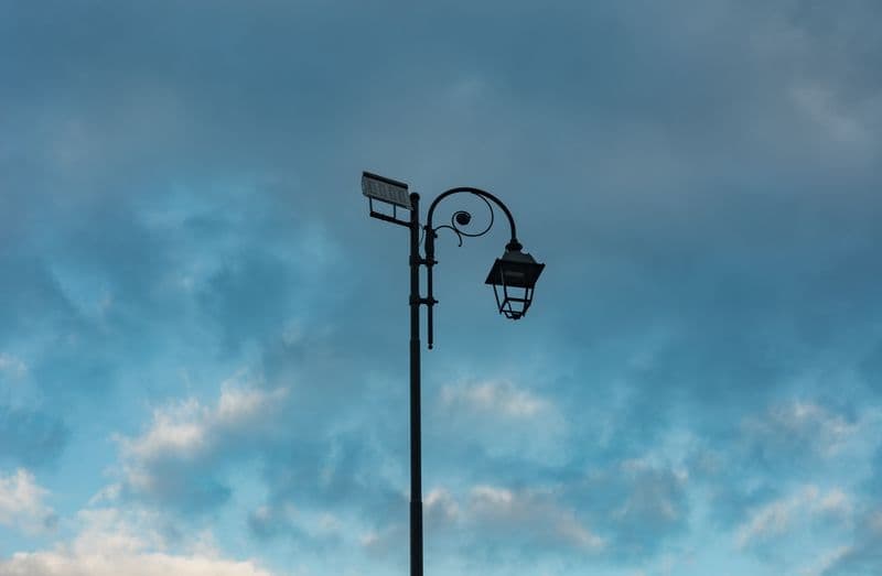 Solar-powered street light with panel mounted on a pole