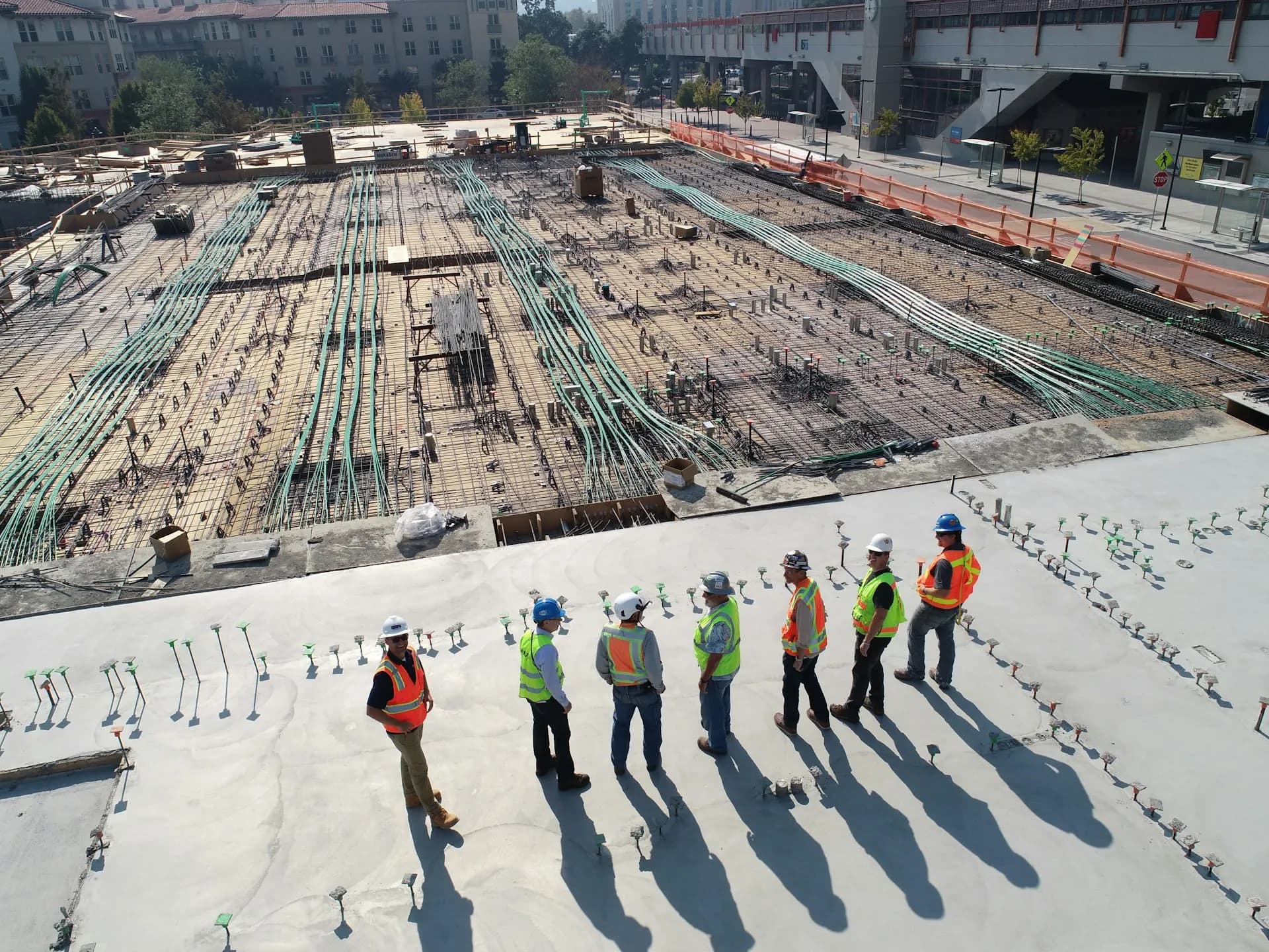 Engineering team inspecting rebar on a large construction site