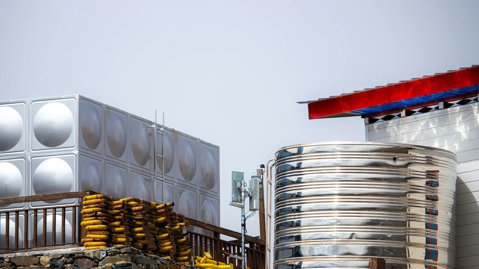 Large water storage tanks and distribution equipment under a clear sky